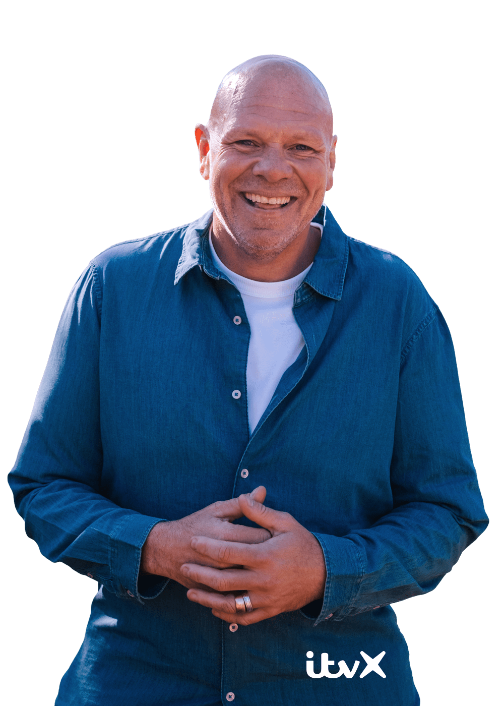 Person wearing a blue button-up shirt outdoors, standing with hands clasped in front, with the ITVX logo in the corner.