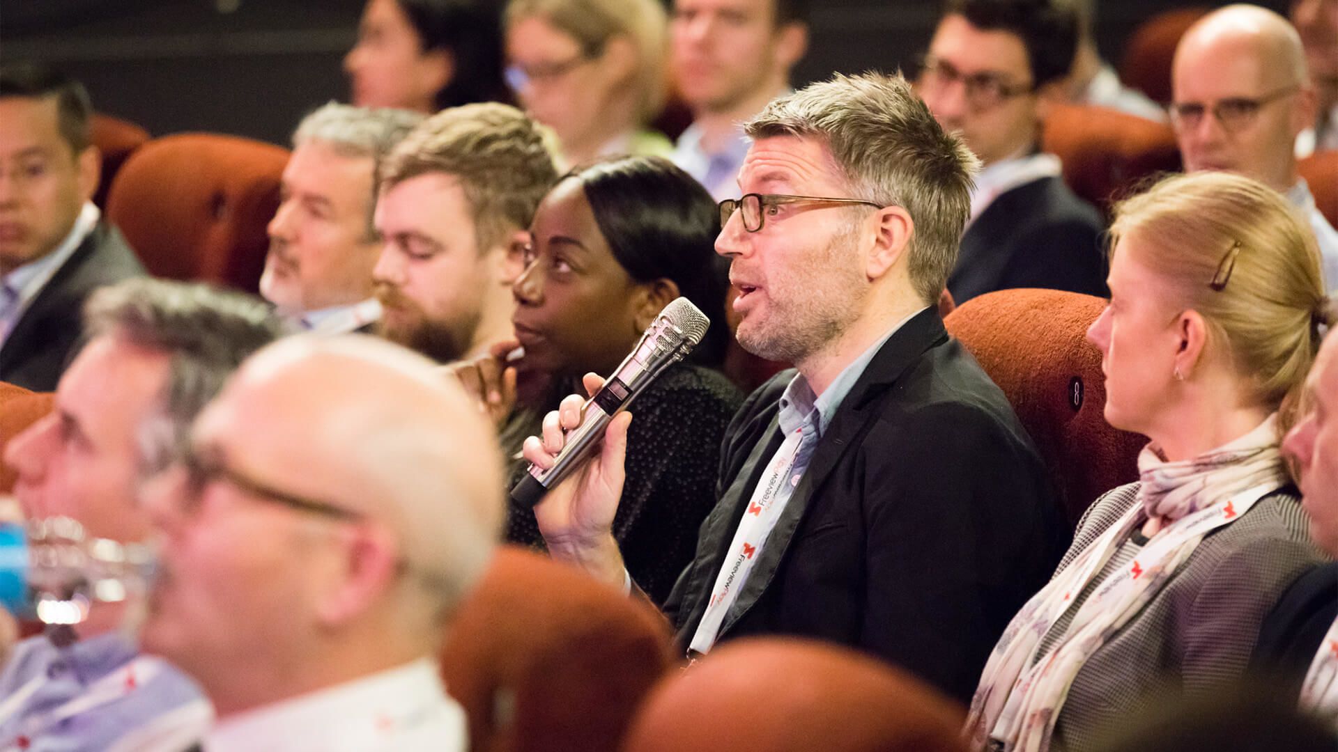 Member of the audience asks the panel a question