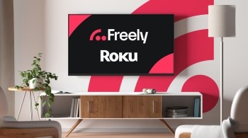 Freely x Roku written on a tv with a pink freely logo in the background in a living room