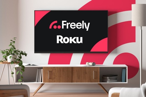 Freely x Roku written on a tv with a pink freely logo in the background in a living room
